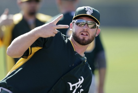 Oakland Athletics pitcher Ryan Cook gestures while stretching during spring training baseball practice Saturday, Feb. 15, 2014, in Scottsdale, Ariz. Cook's training may be "a couple weeks behind" the rest of the pitchers because of inflammation in the right shoulder, according to Athletics manager Bob Melvin. (AP Photo/Gregory Bull)